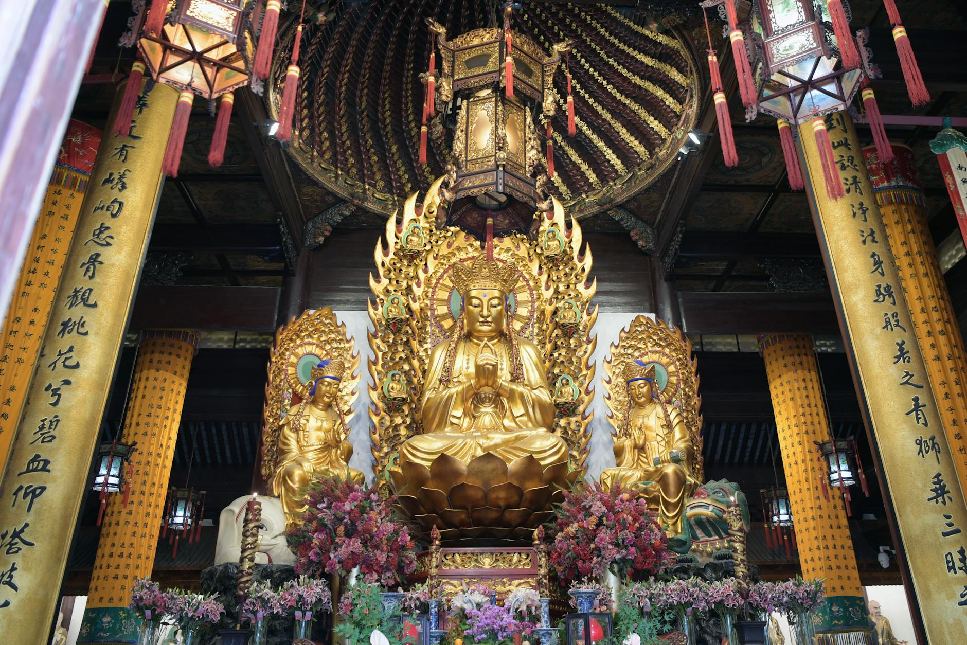Ornate golden Buddha statue in a Shanghai temple with intricate decorations.