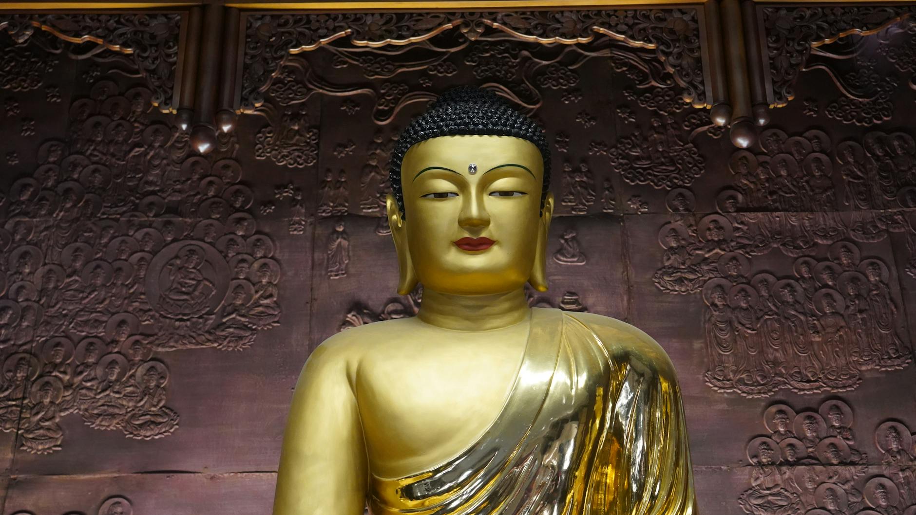 A stunning golden Buddha statue in a Seoul temple, reflecting serenity and artistry.