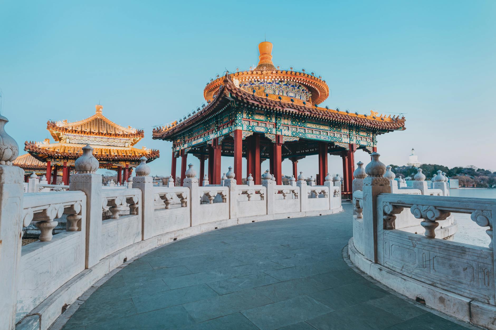 A beautiful traditional Chinese pavilion in Beijing under a clear blue sky.