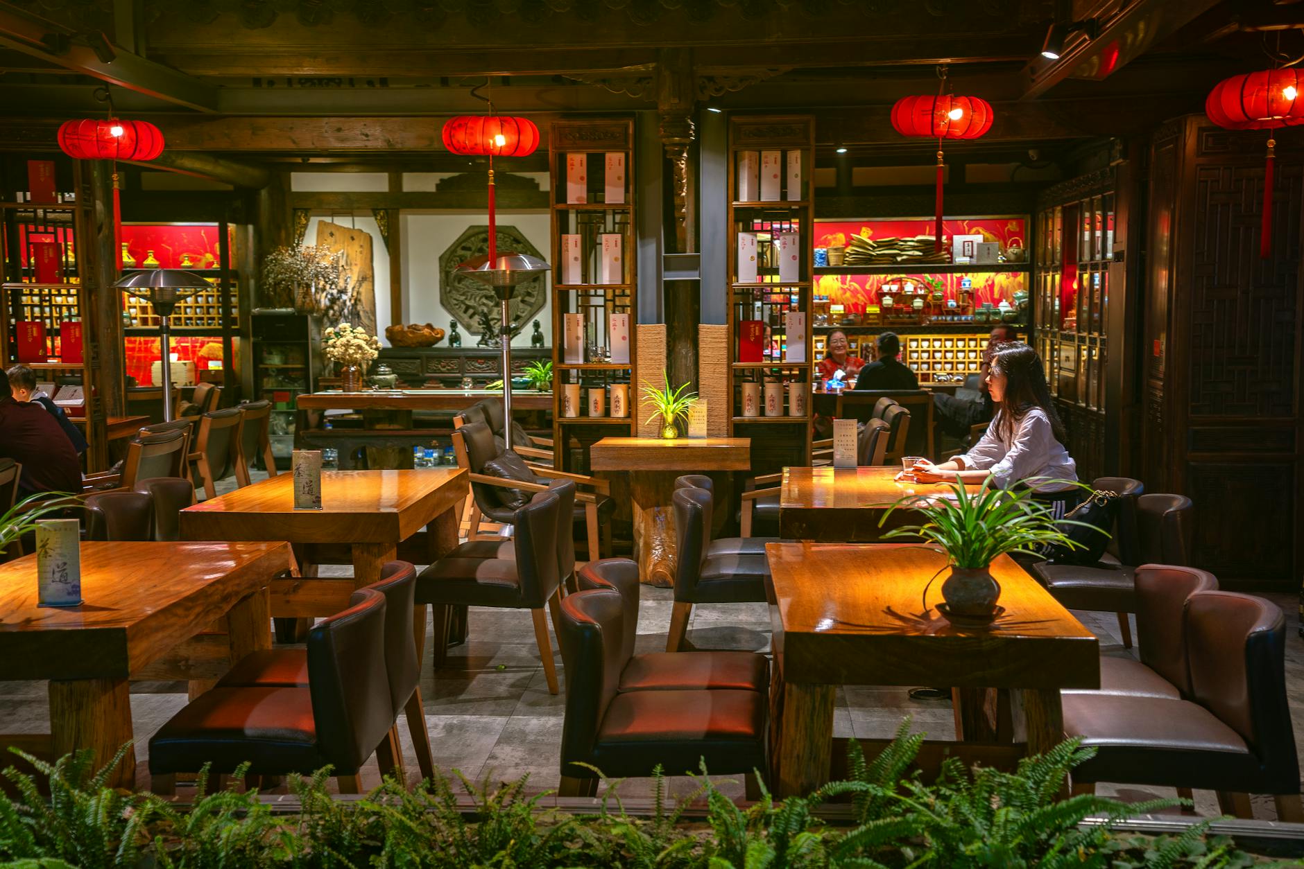 Cozy traditional Chinese tea house interior with warm lighting in Chengdu, Sichuan.