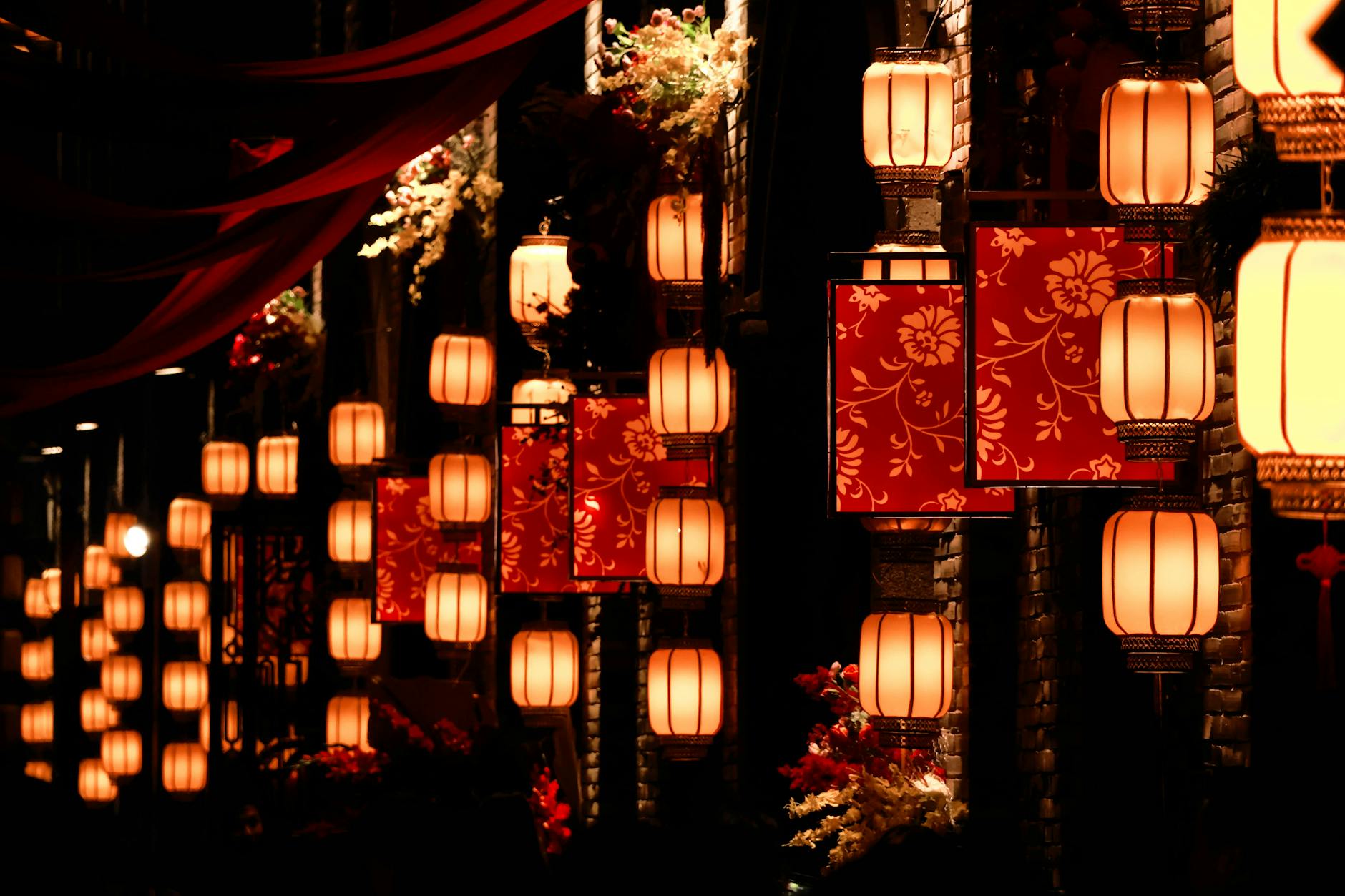 A stunning display of traditional lanterns lighting up a street at night, creating a festive atmosphere.