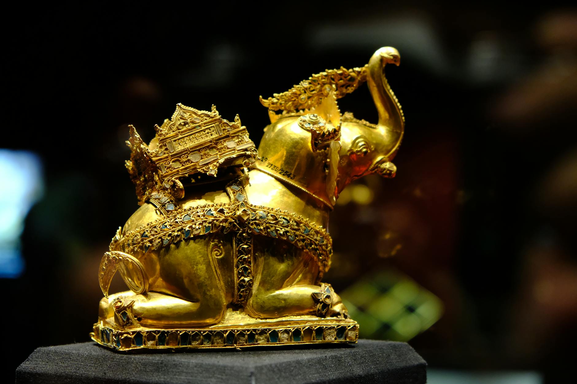 Intricate golden elephant sculpture on display in Ayutthaya's museum, symbolic of Thai art and culture.