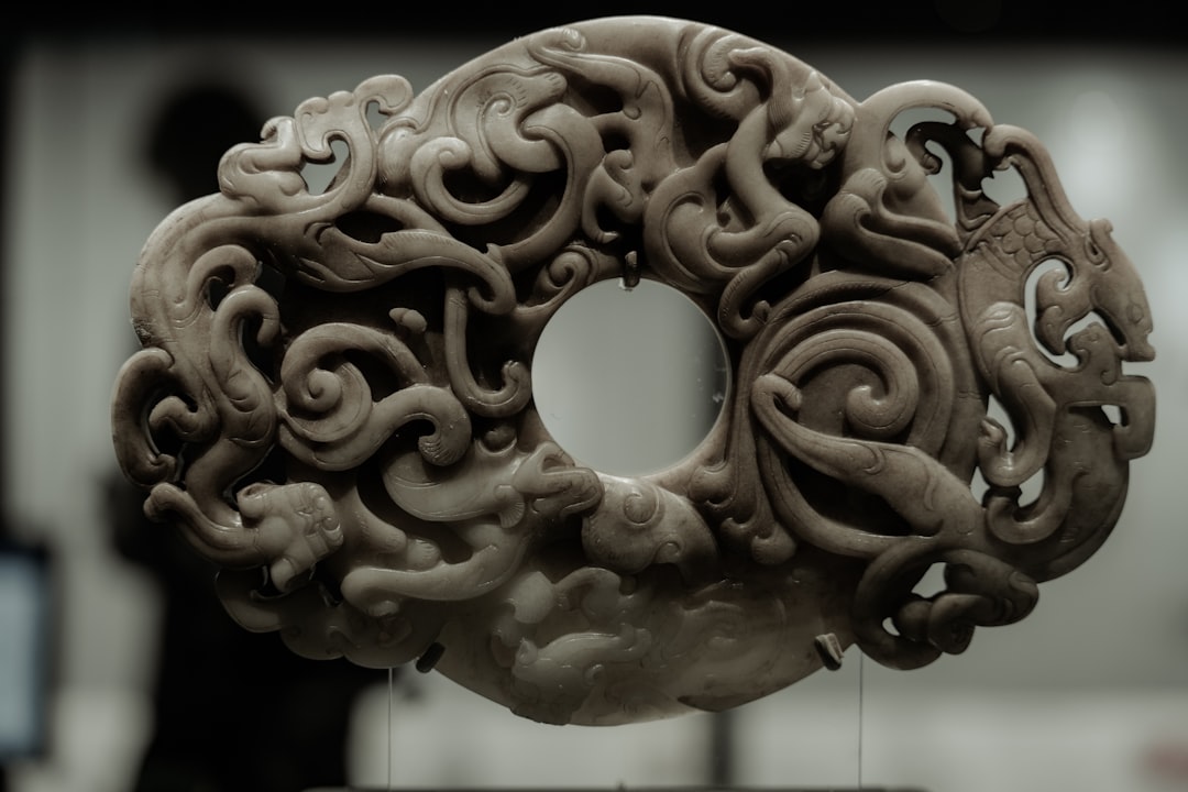 An intricately carved, circular jade artifact.