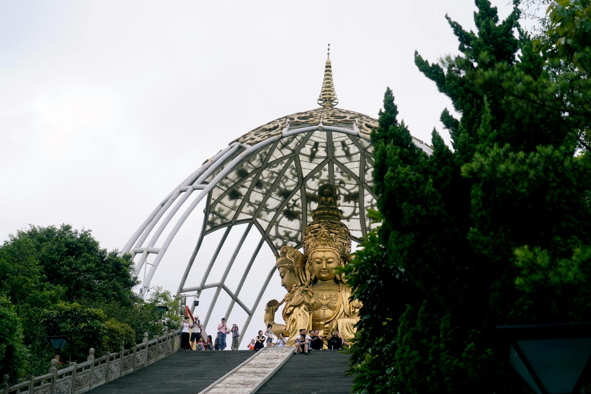 People visiting the majestic gilded Buddha statue at Huaxing Temple, Shenzhen.