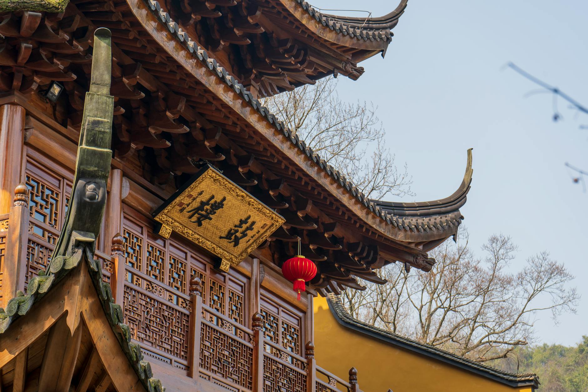 Close-up of ornate Chinese temple architecture with intricate details in Hangzhou, China.