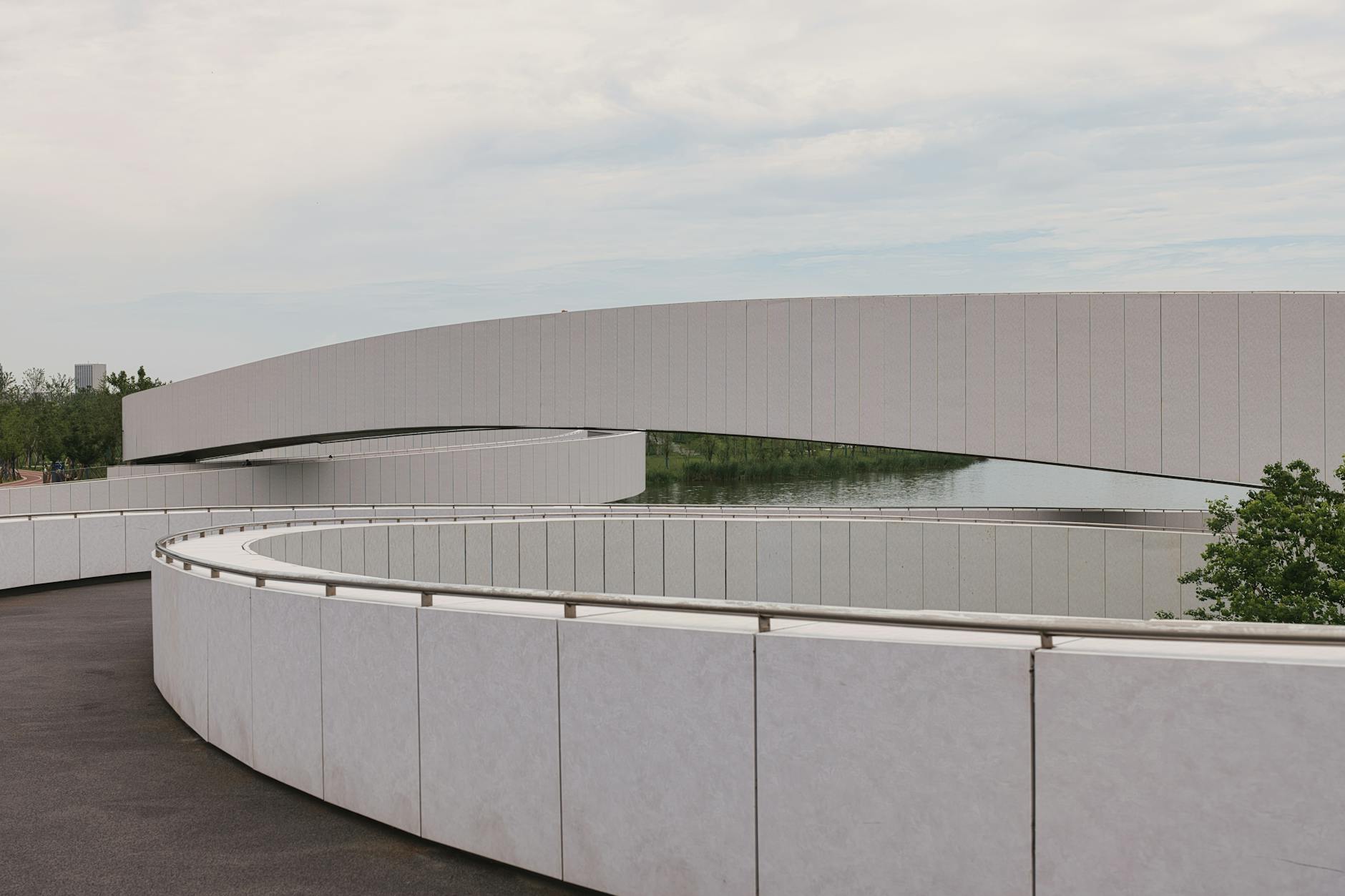 Curved modern footbridge with minimalist design in Nanhuixincheng Town, Shanghai.
