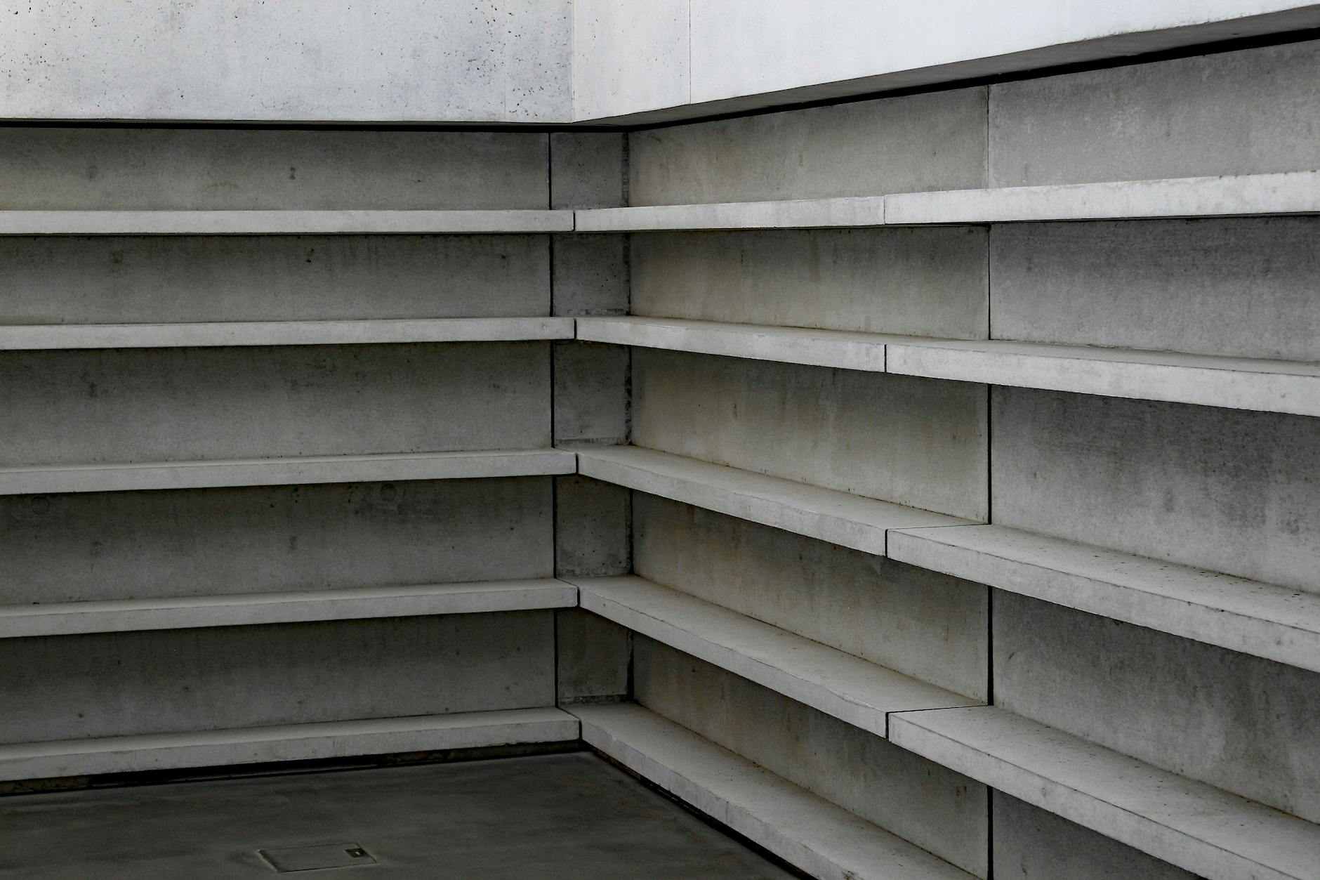 Minimalist concrete shelving in modern architectural design, showcasing clean lines.