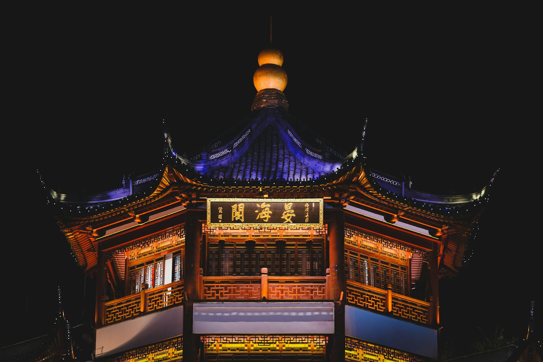 Stunning night view of a traditional Chinese pagoda beautifully illuminated in Shanghai.