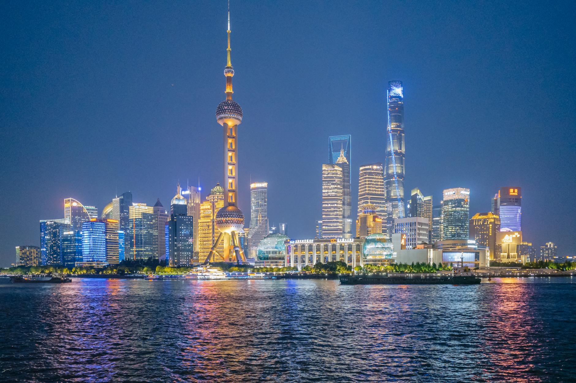 Spectacular night view of Shanghai skyline with the iconic Oriental Pearl Tower lighting up the cityscape.
