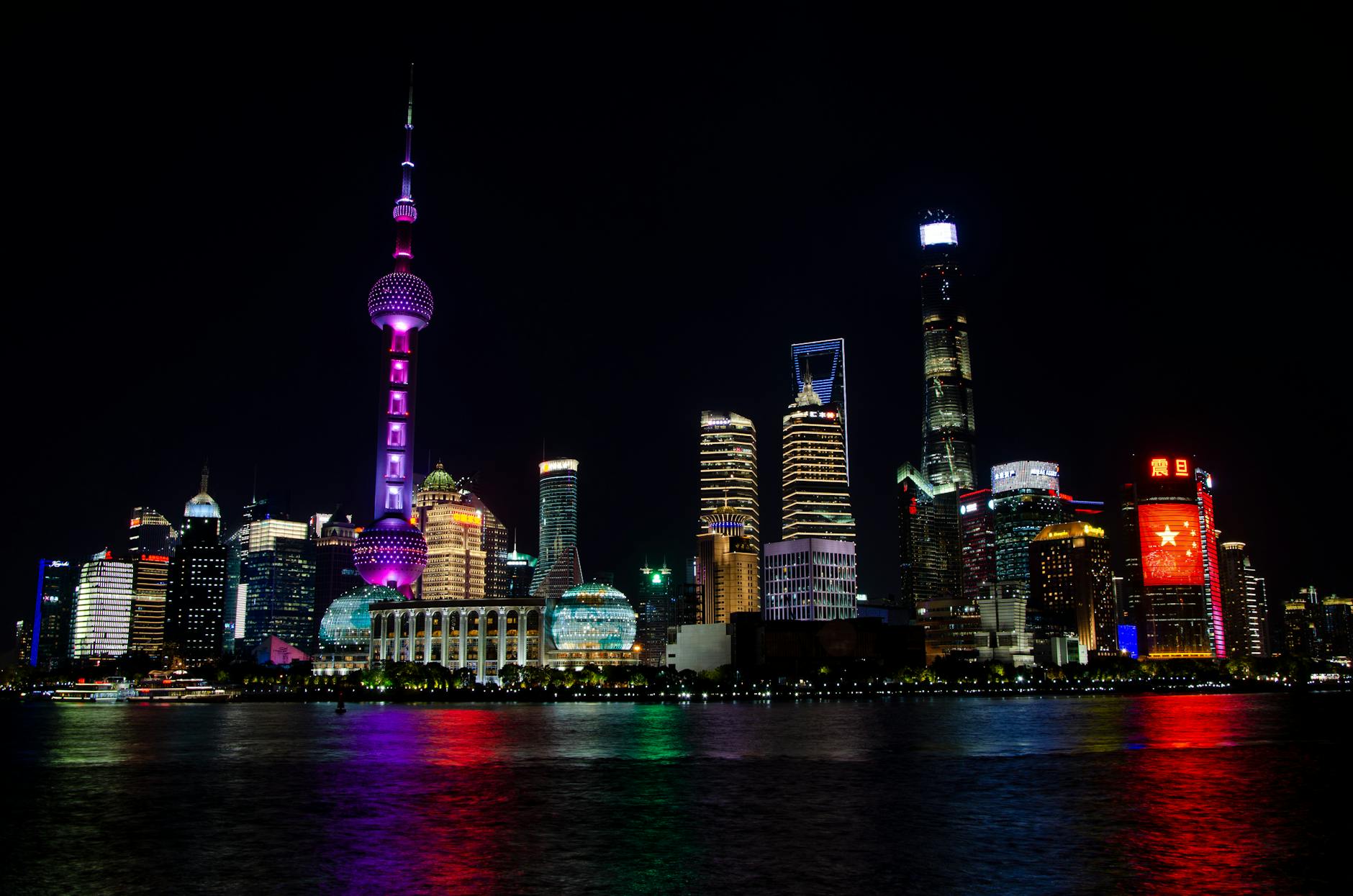 Beautiful view of Shanghai's illuminated skyline at night featuring the iconic Oriental Pearl Tower.
