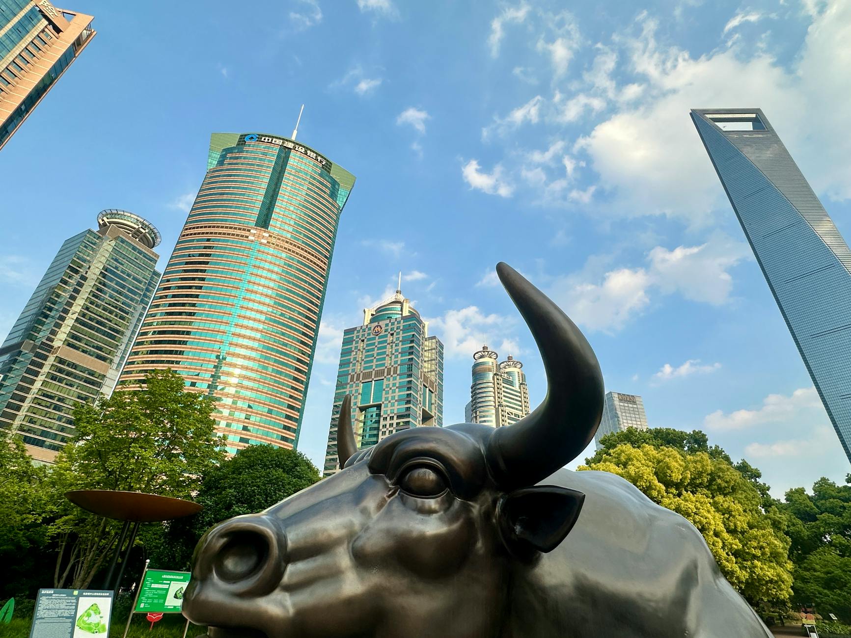 Stunning view of Shanghai's skyline with the iconic Bund Bull in the foreground.