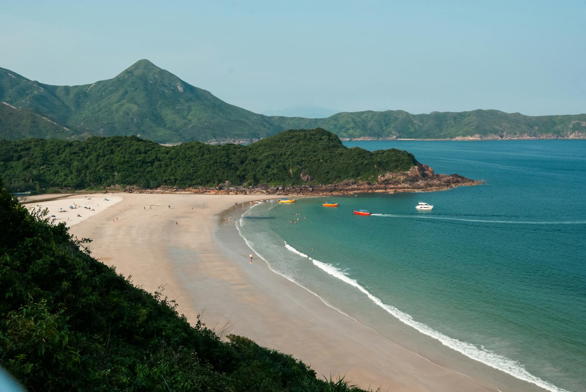 Beautiful aerial view of Sai Kung Peninsula's sandy beach and turquoise waters.