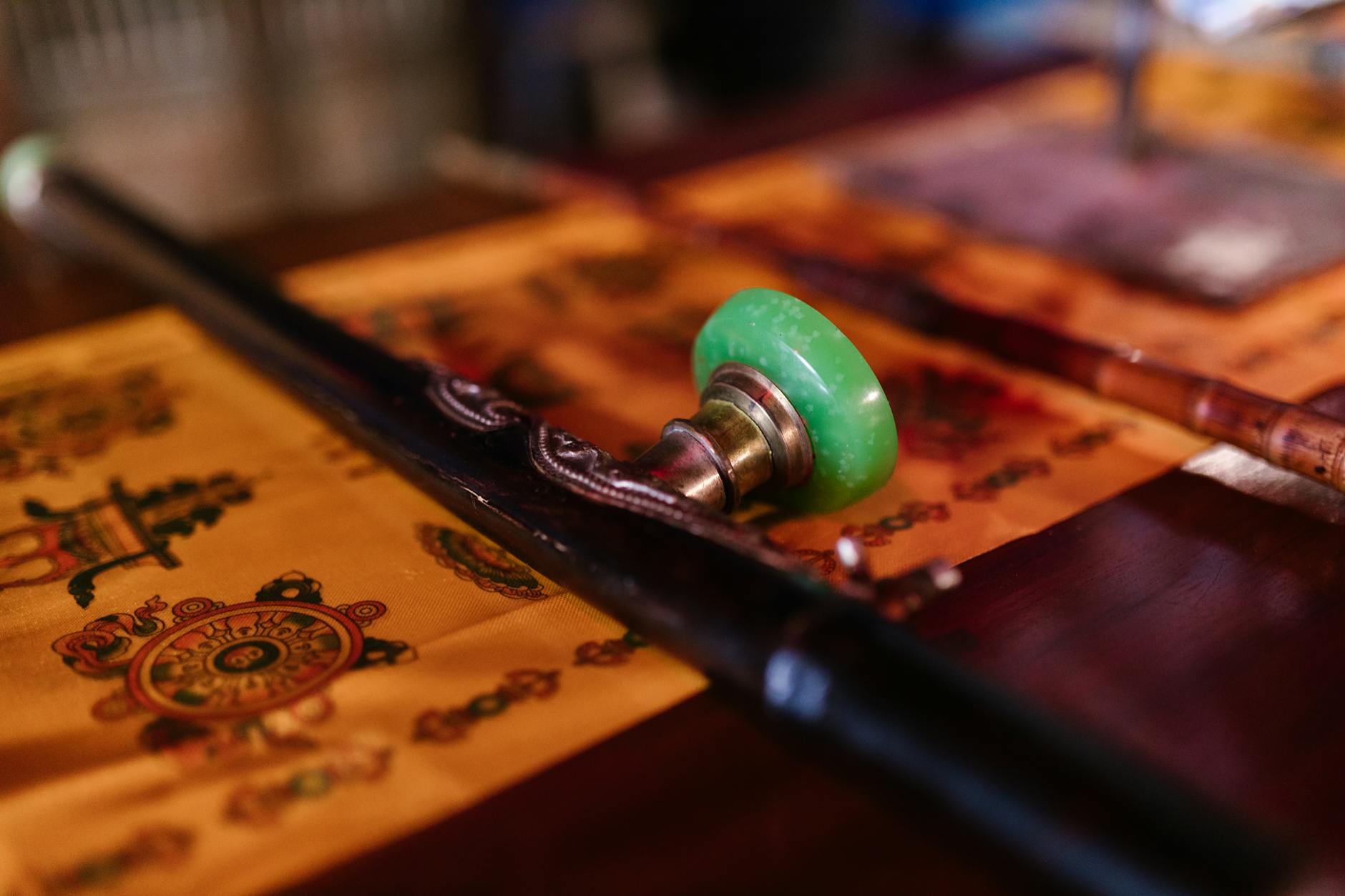 Close-up of traditional Buddhist ritual objects placed on a decorative fabric. Perfect for spirituality and cultural concepts.