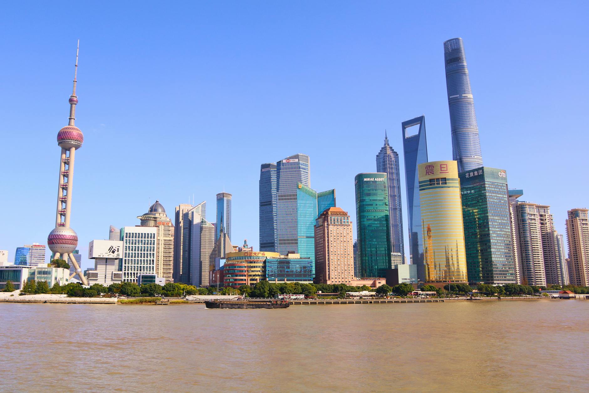 Stunning view of Shanghai's modern skyline featuring the iconic Oriental Pearl Tower on a sunny day.