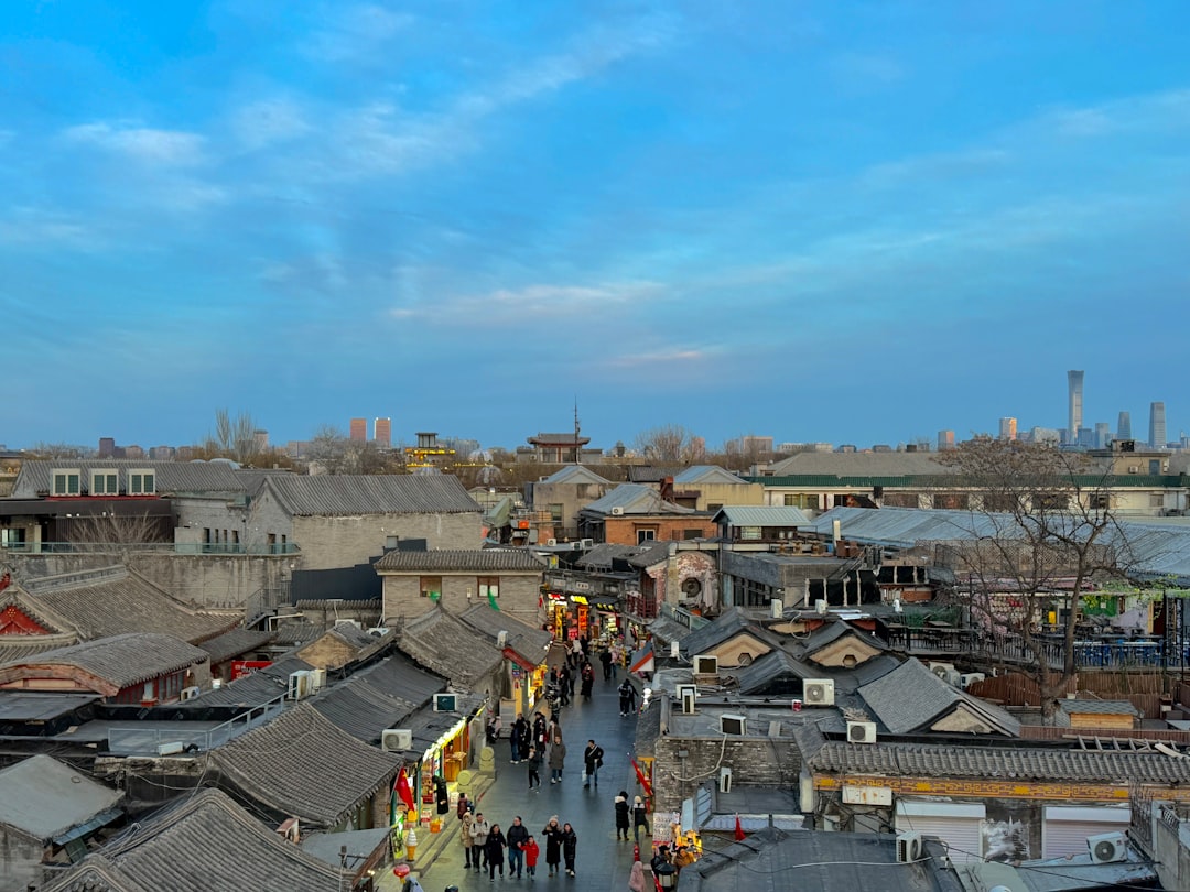 Traditional buildings line a bustling street at dusk.