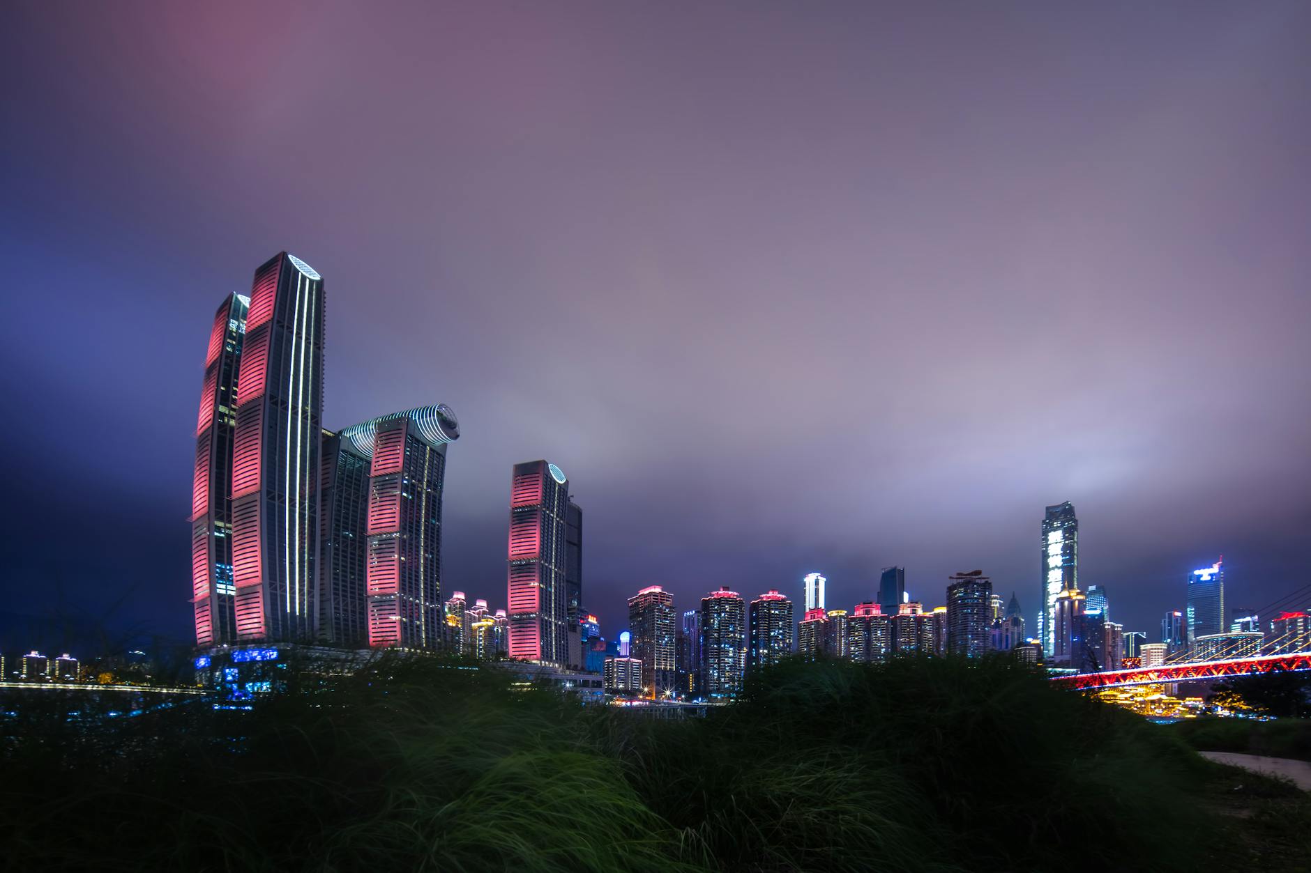 Stunning view of the illuminated Chongqing skyline at night featuring modern skyscrapers.