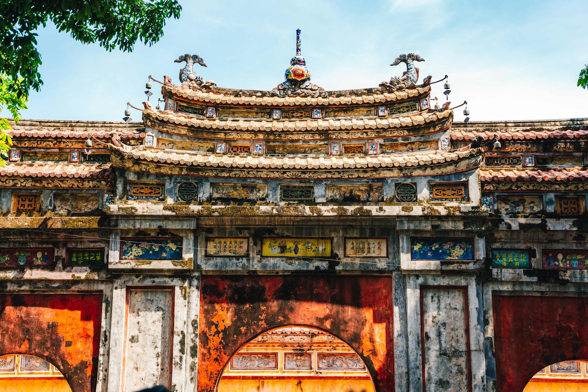 Explore the intricate architecture of a historic gate in the Imperial City of Hue, Vietnam.