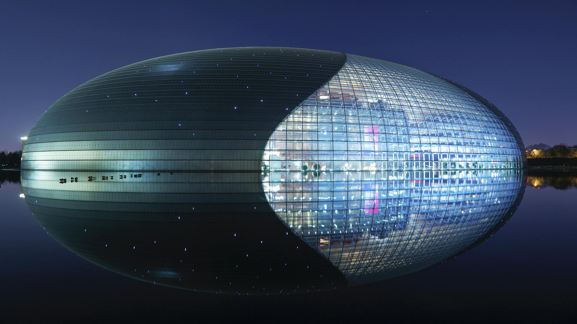 Futuristic architecture of Beijing's National Centre for Performing Arts at night.