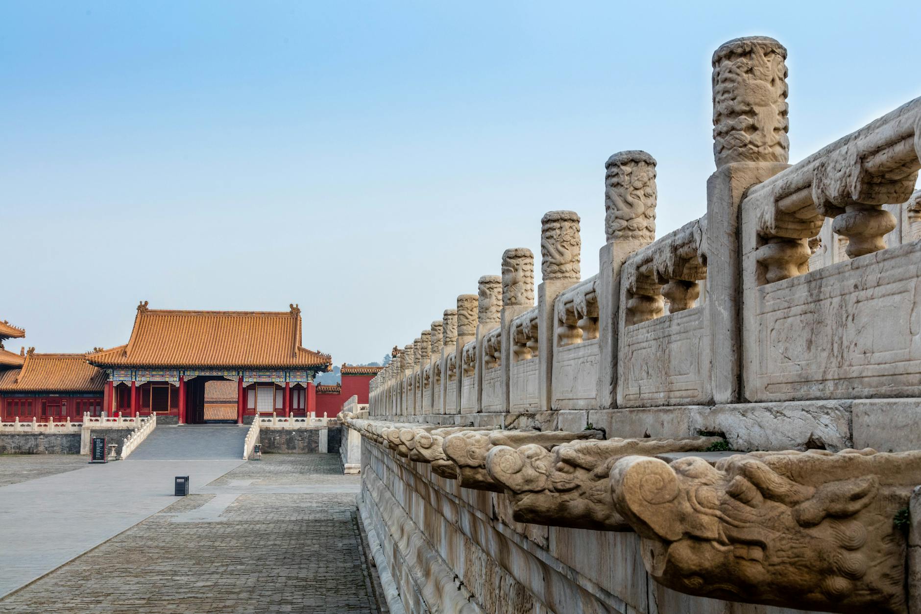 A view of historic architecture within the Forbidden City, Beijing, highlighting ornate stone carvings.