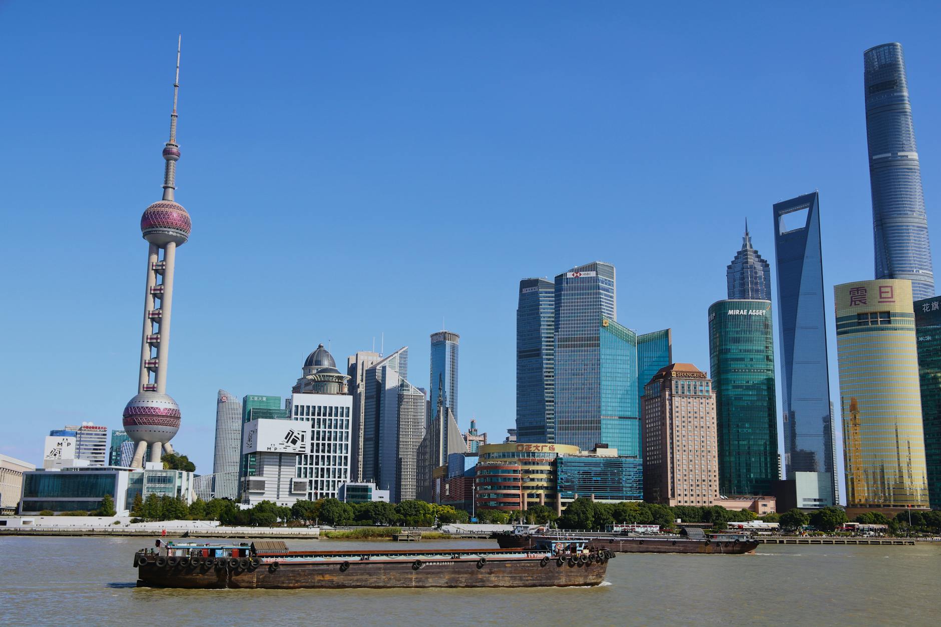 View of Shanghai's iconic skyline featuring the Oriental Pearl Tower and modern skyscrapers.