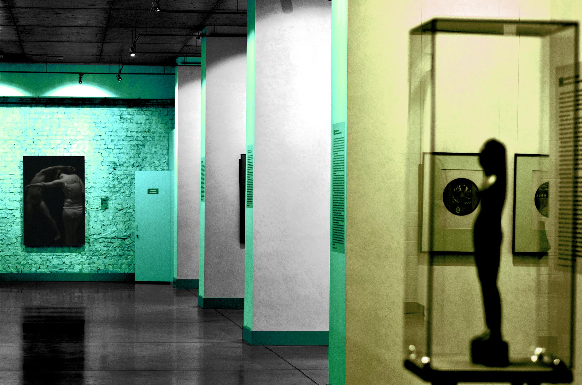 Explore a modern art gallery featuring sculptures and paintings under ambient lighting.