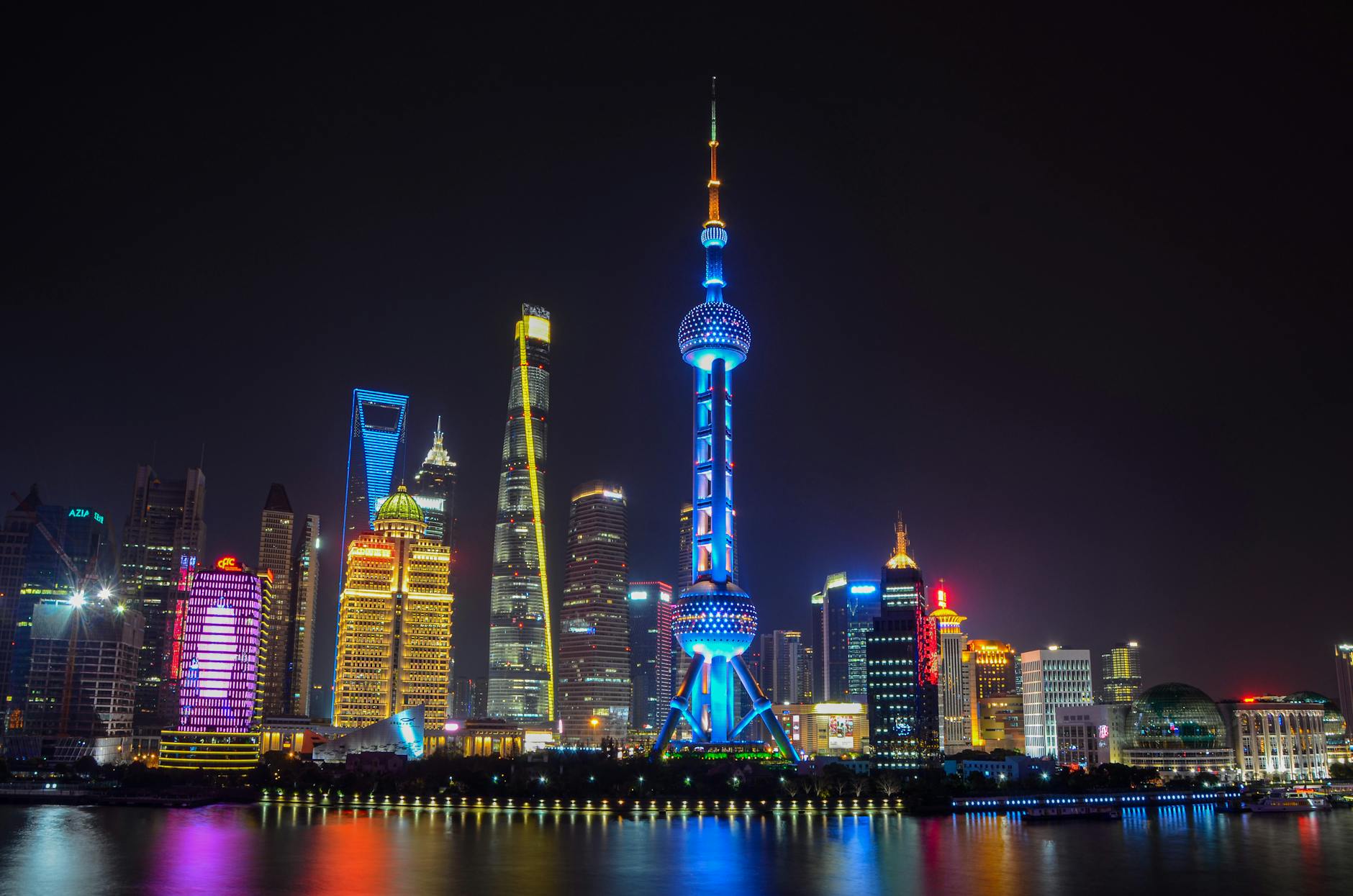 Stunning view of Shanghai's illuminated skyline featuring the iconic Oriental Pearl Tower.