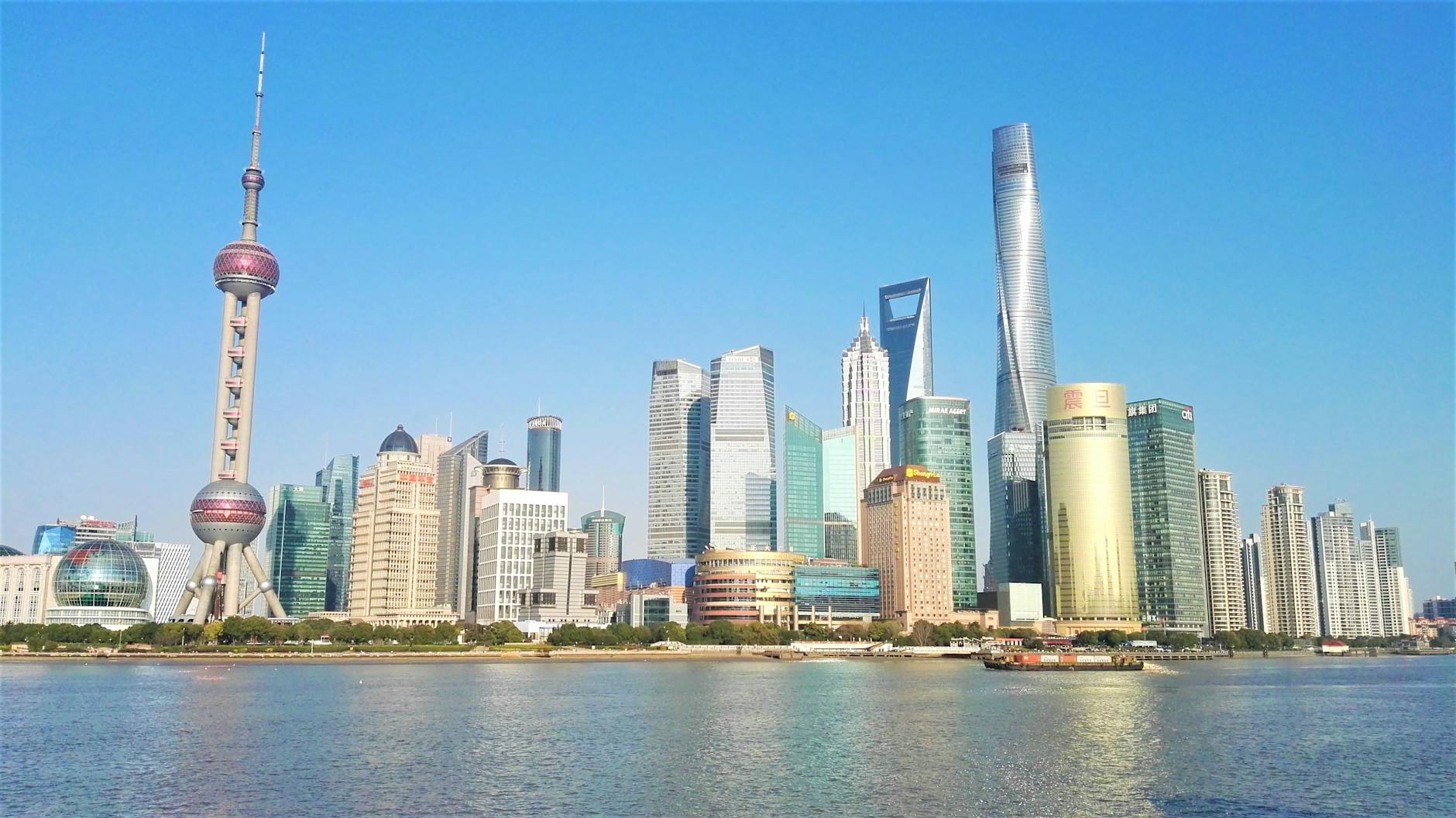 Vibrant Shanghai skyline featuring the iconic Oriental Pearl Tower and modern skyscrapers.