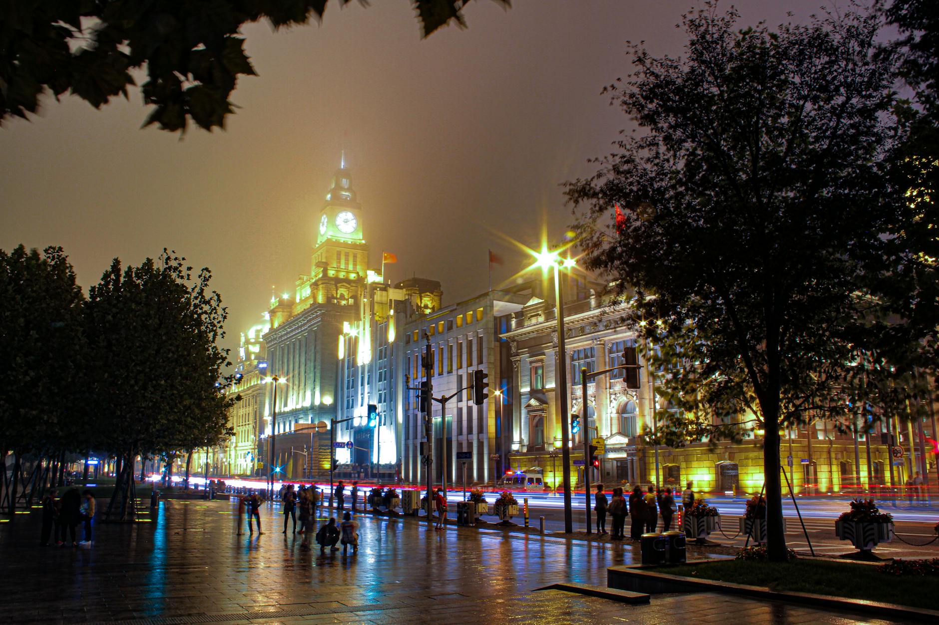 Stunning nighttime view of The Bund in Shanghai with illuminated architecture and bustling streets.