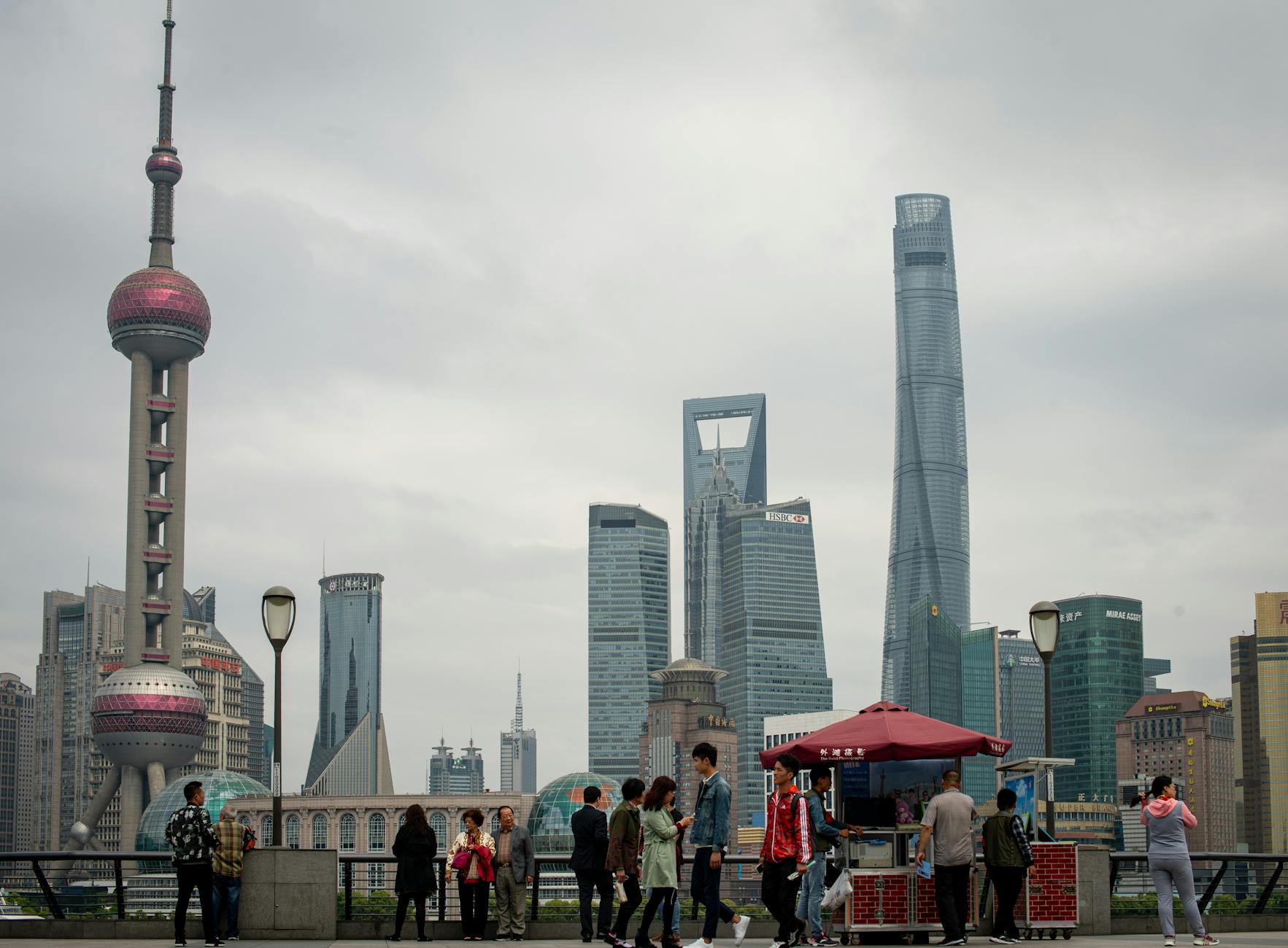 Panoramic view of Shanghai's iconic skyline featuring the Oriental Pearl Tower and bustling cityscape.