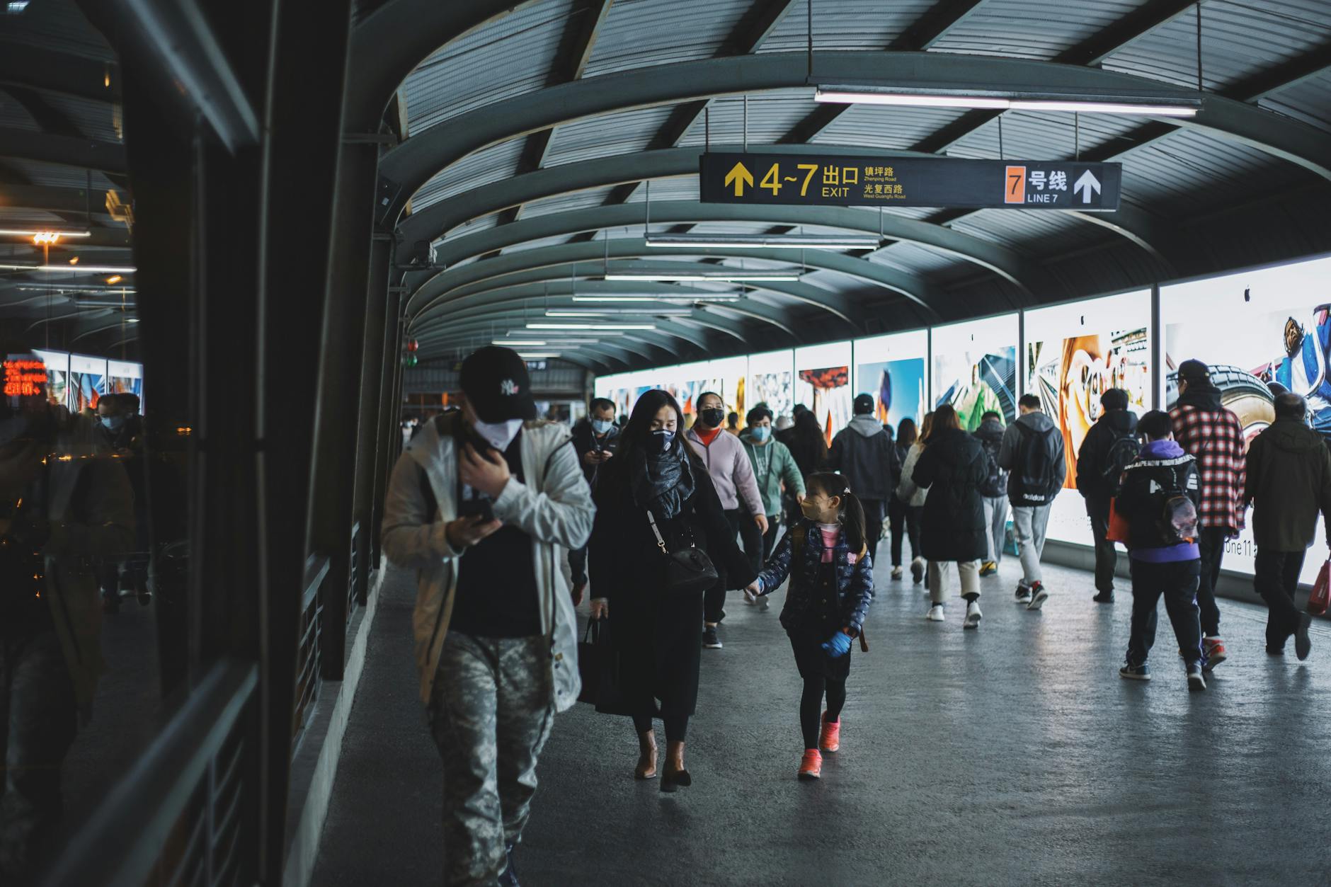 A busy scene of commuters wearing masks in a Shanghai subway station during the COVID-19 pandemic.