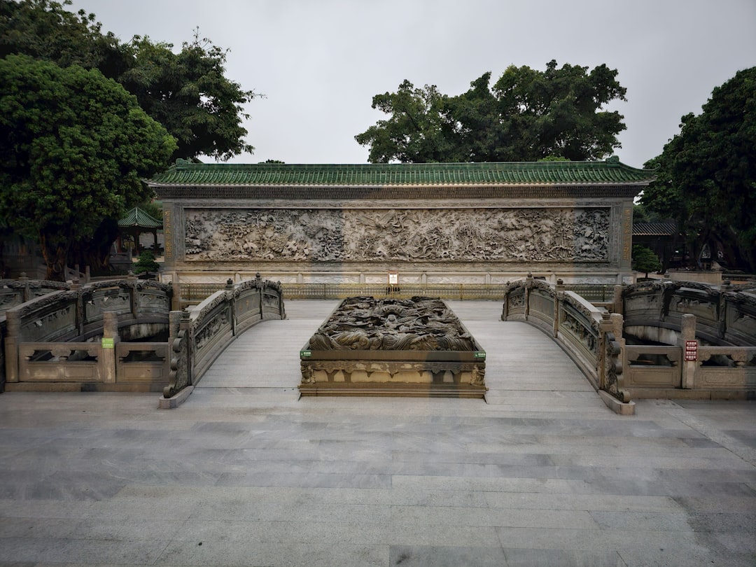 a stone bench sitting in the middle of a park