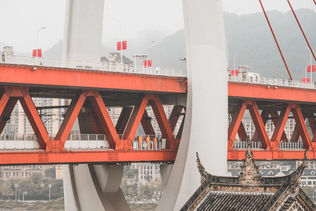 a red and white bridge over a body of water