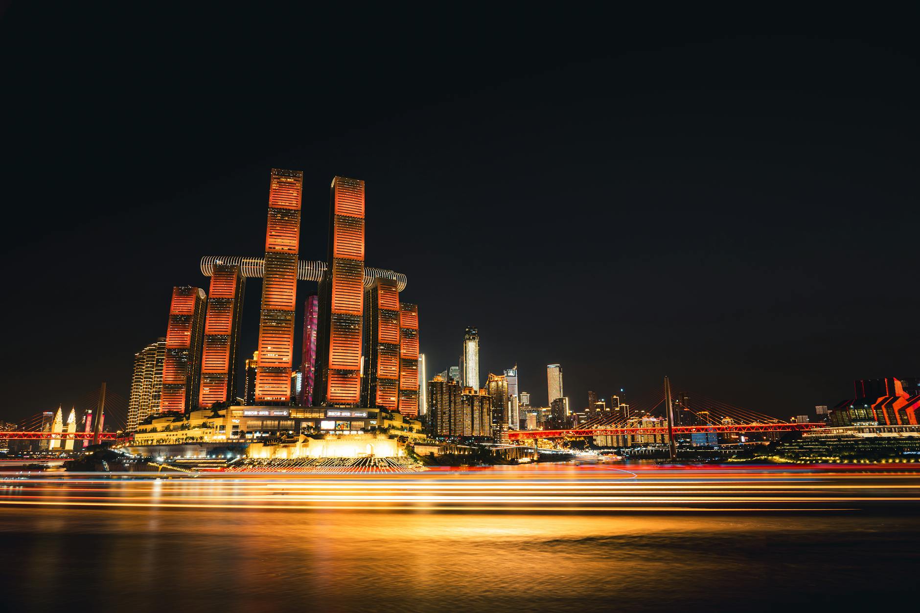 Stunning view of Chongqing skyline with colorful illuminated skyscrapers at night. A vibrant display of urban architecture.