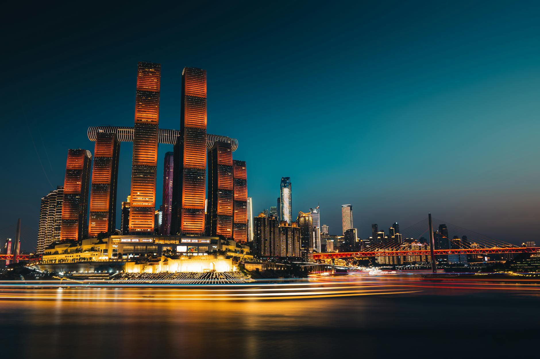 Captivating night view of Chongqing skyline, featuring modern skyscraper lighting and vibrant river reflections.