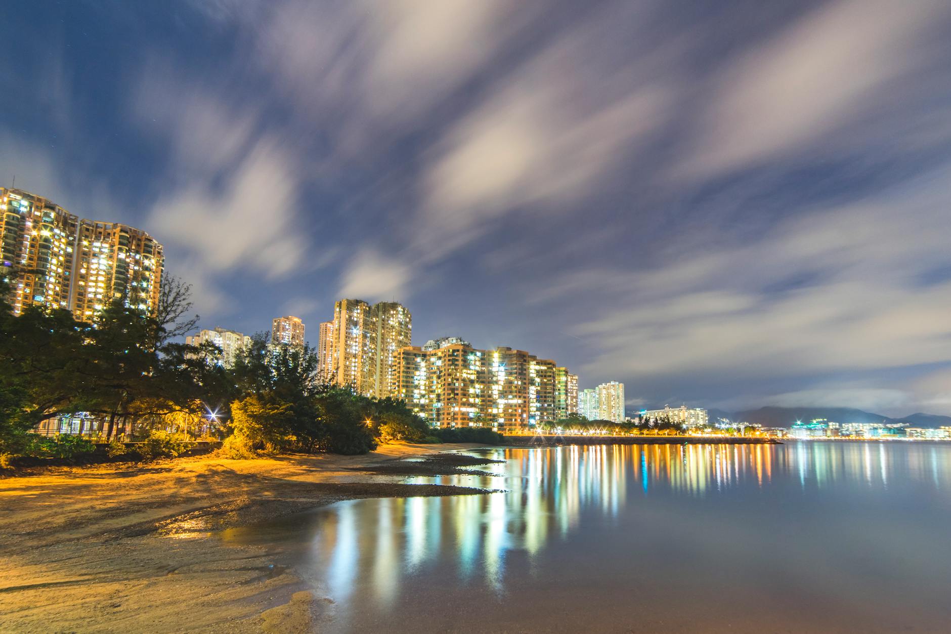 Stunning night view of Kowloon's illuminated skyline reflecting on the waterfront.