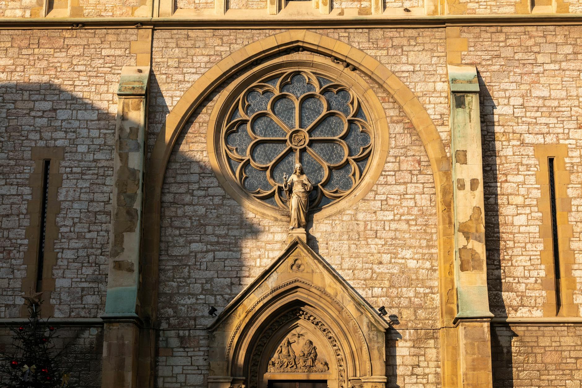 Close-up of Sacred Heart Cathedral's intricate rose window and facade in Sarajevo.