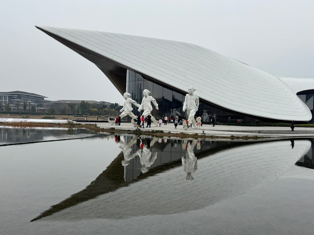 A large white building sitting next to a body of water
