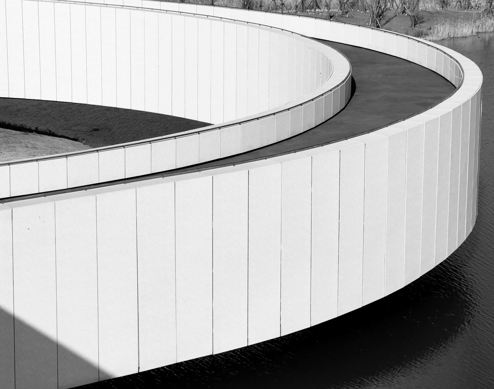 Black and white image of a modern circular walkway in Shanghai, China.