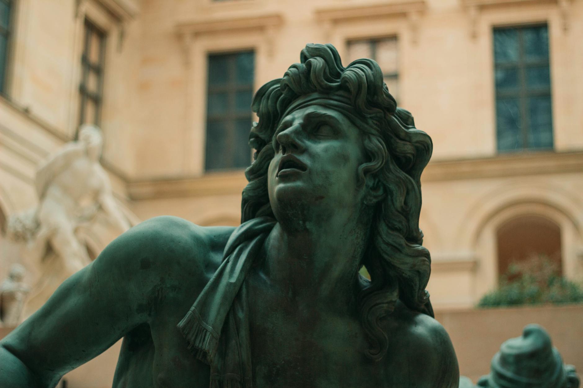 Detailed view of a dramatic sculpture within The Louvre Museum, Paris.