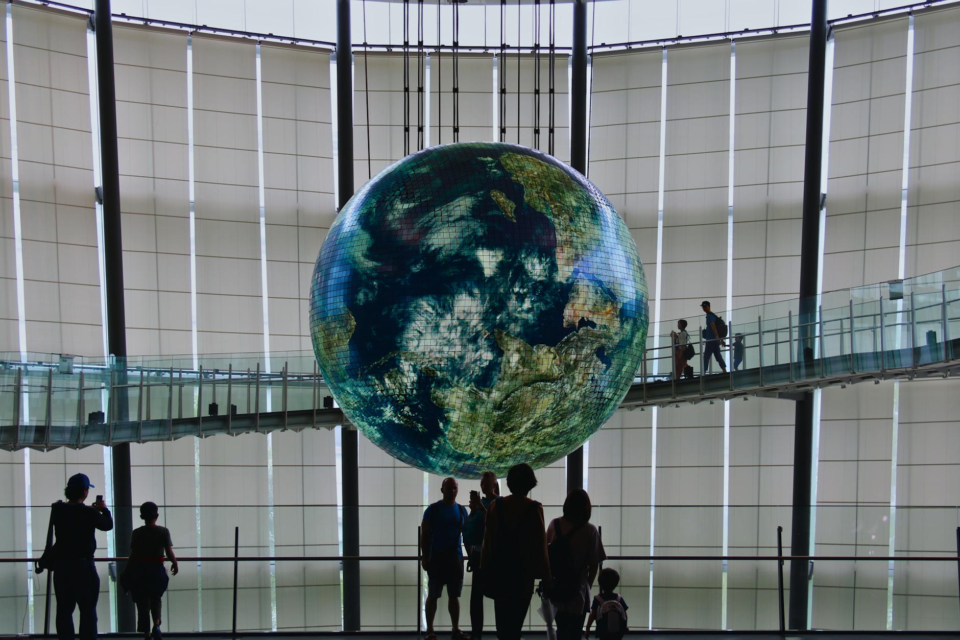 People observing the Earth sculpture at National Museum of Science and Innovation, Tokyo.