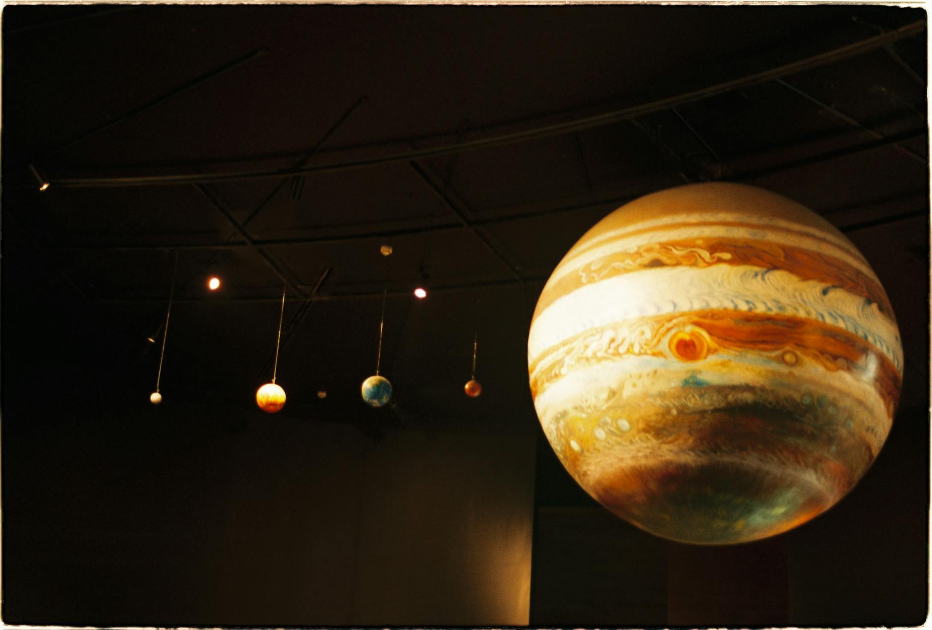 Scale models of solar system planets in a planetarium exhibit.