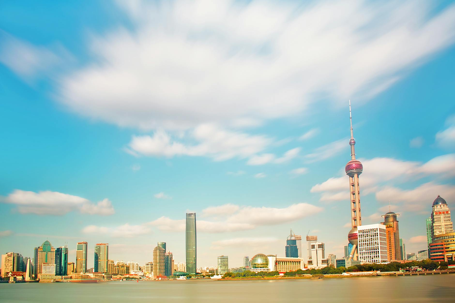 Breathtaking view of Shanghai's modern skyline with the iconic Oriental Pearl Tower and waterfront.