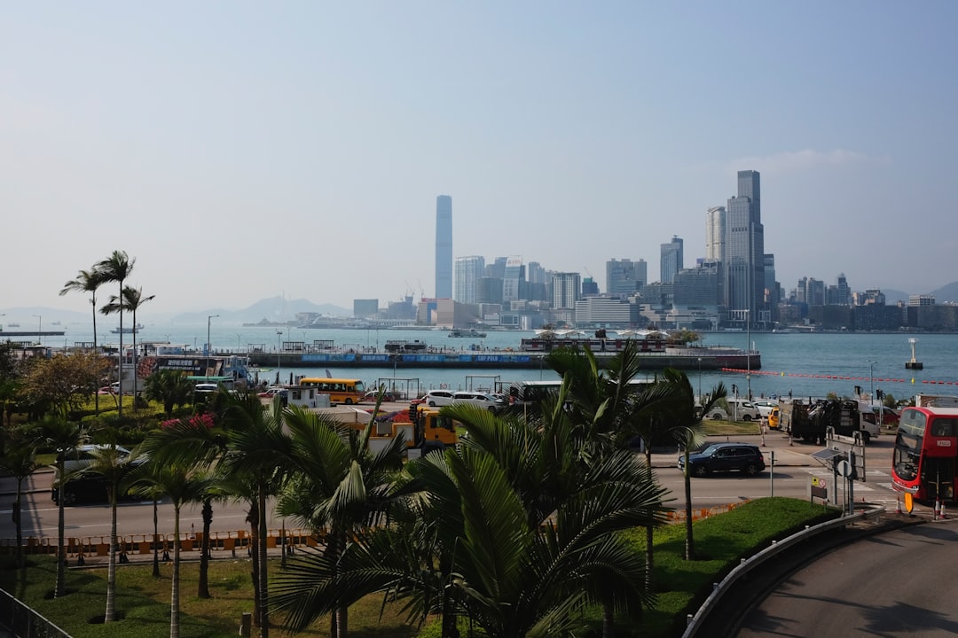 City skyline across a bay with boats and palm trees