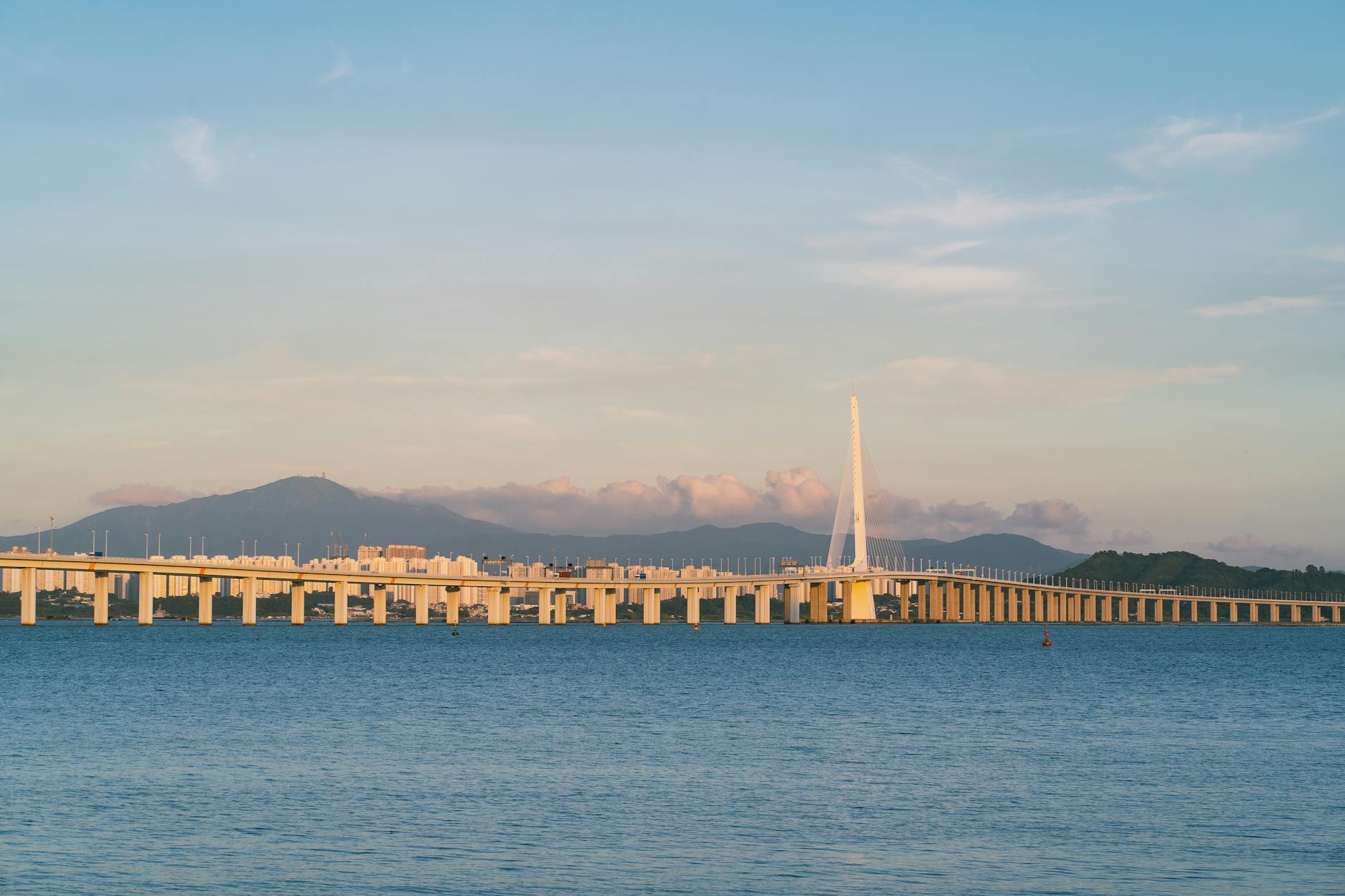 Panoramic view of the Shenzhen Bay Bridge connecting Hong Kong and Shenzhen at sunset.