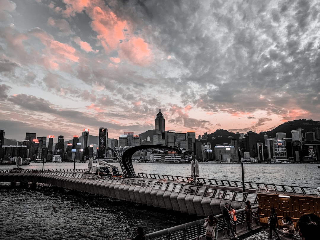 city skyline under cloudy sky during sunset