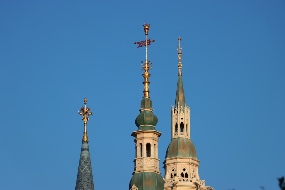 a building with towers and a cross on top