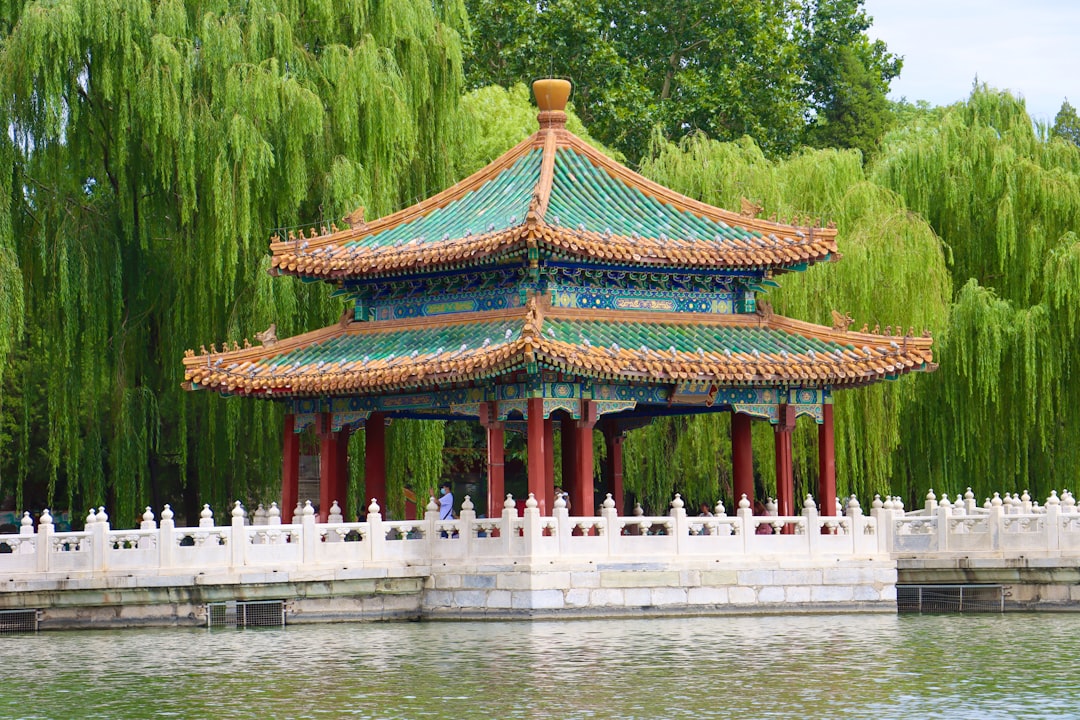 a building with a red roof surrounded by water