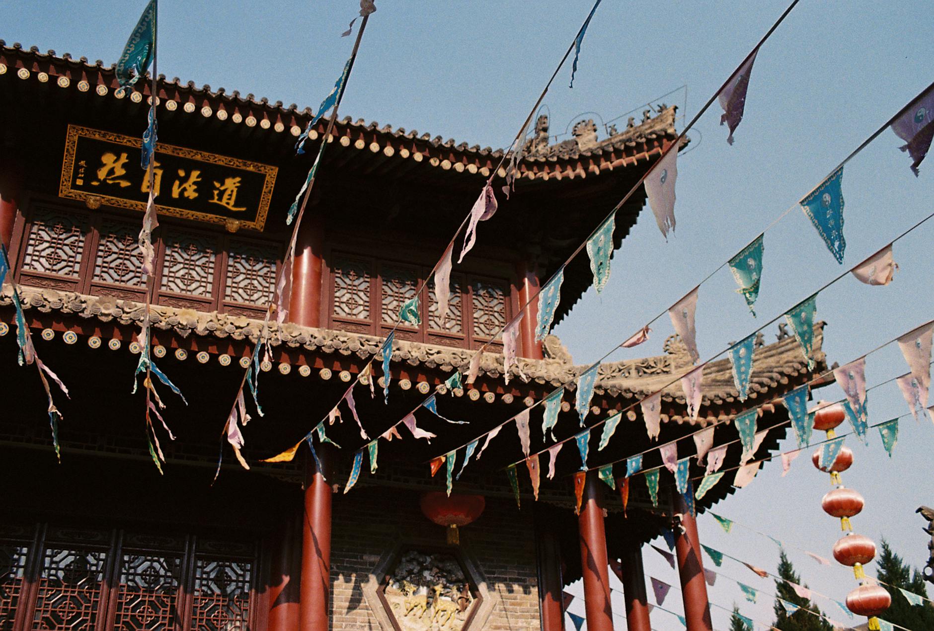 Explore Xi'An's rich cultural heritage with a traditional Chinese temple adorned with colorful flags.
