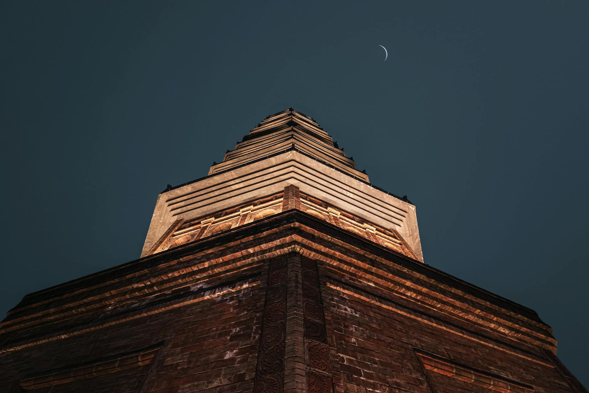 An inspiring upward view of the illuminated Bái Đính Pagoda against a night sky, creating a celestial ambiance.