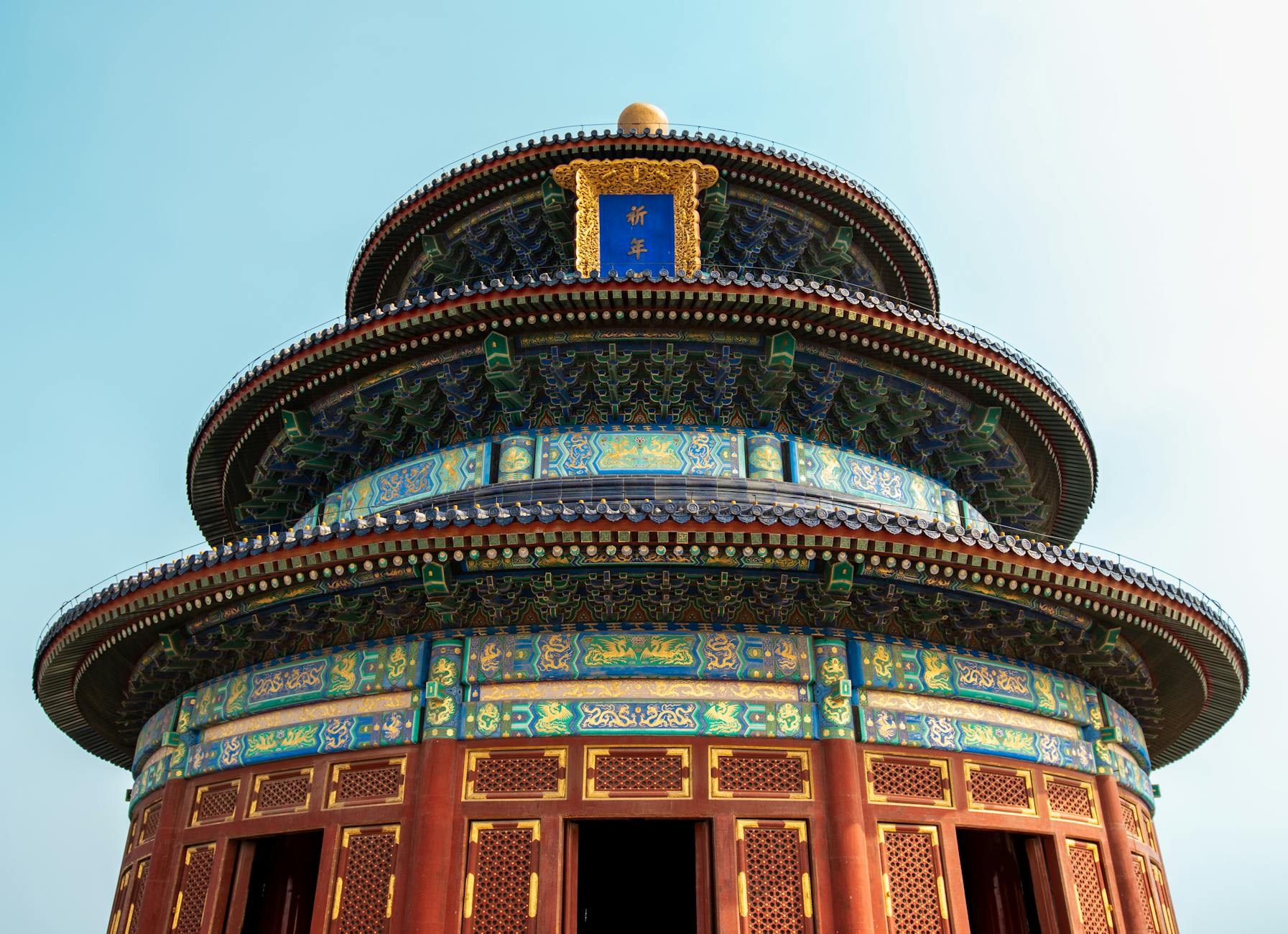 A detailed view of the iconic Temple of Heaven in Beijing, showcasing its intricate architecture under a clear sky.